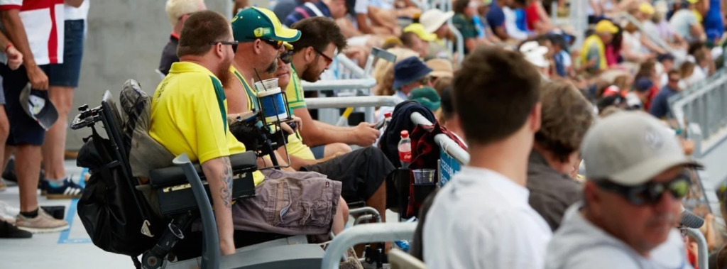 Photo of a man in a wheelchair watching a game on the sideline (sourced from the Optus Stadium website)